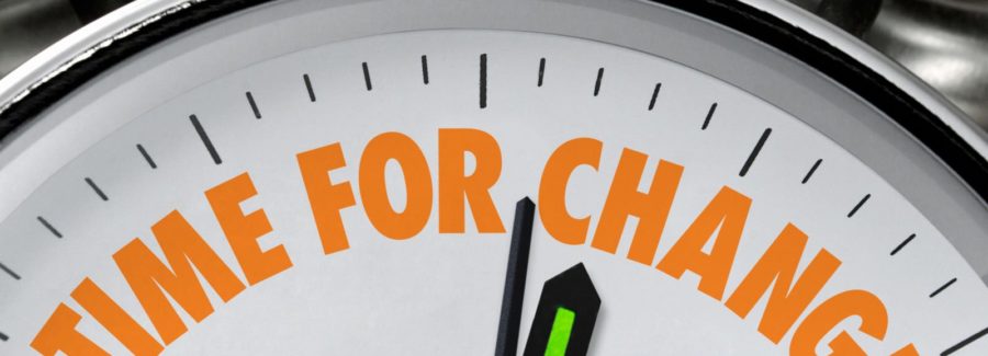 A clock with "Time to Change!" in orange lettering